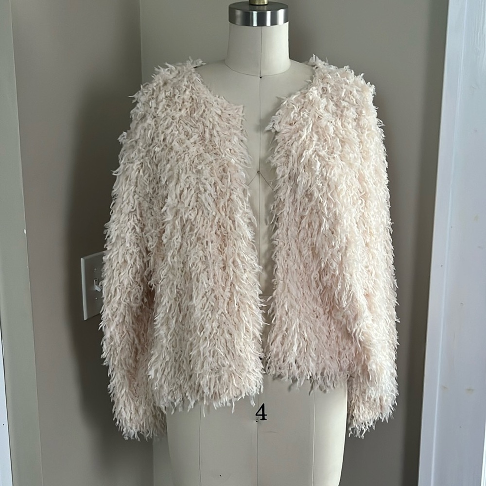 Light pink faux feather cardigan.
